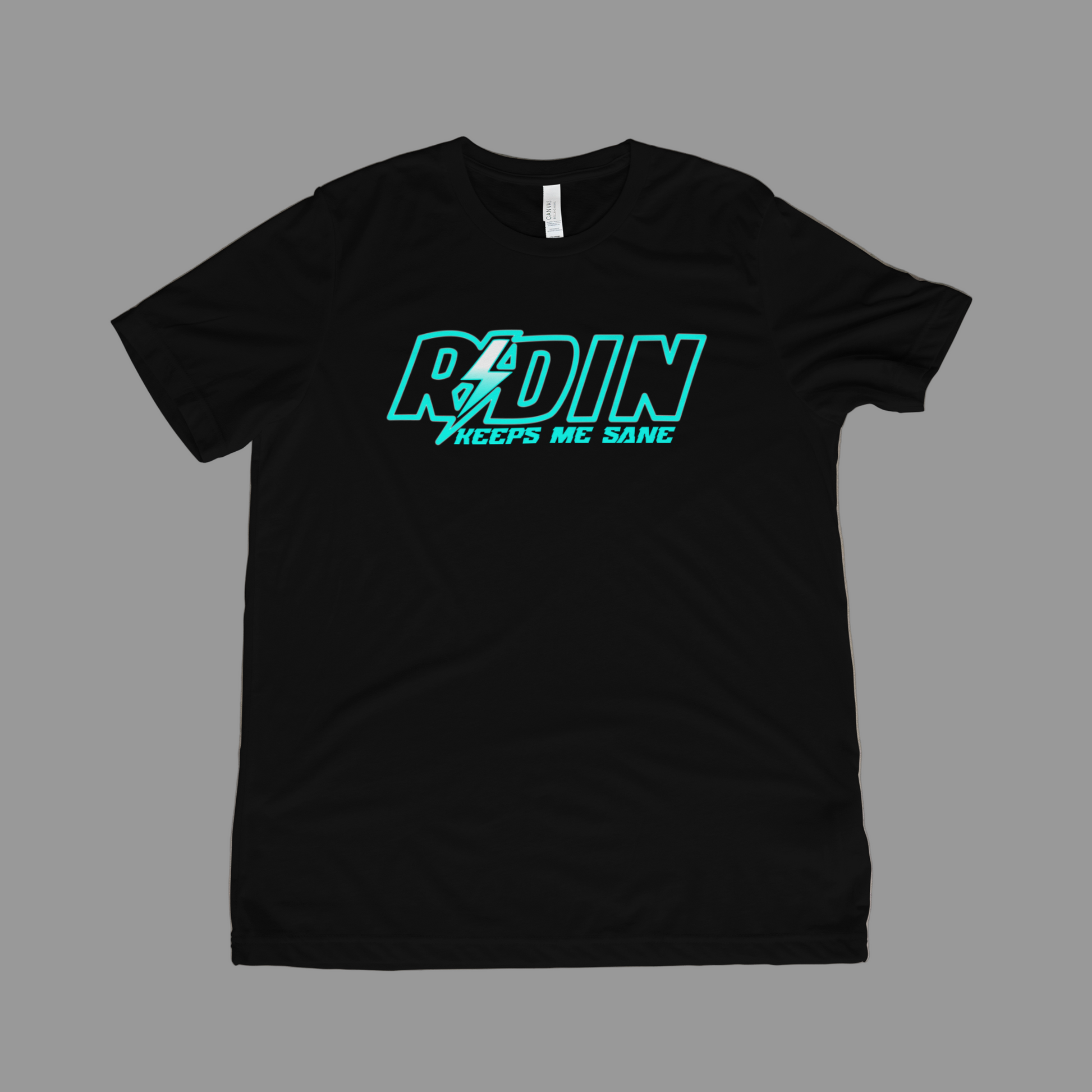 Black t-shirt with teal and white text on a beige surface